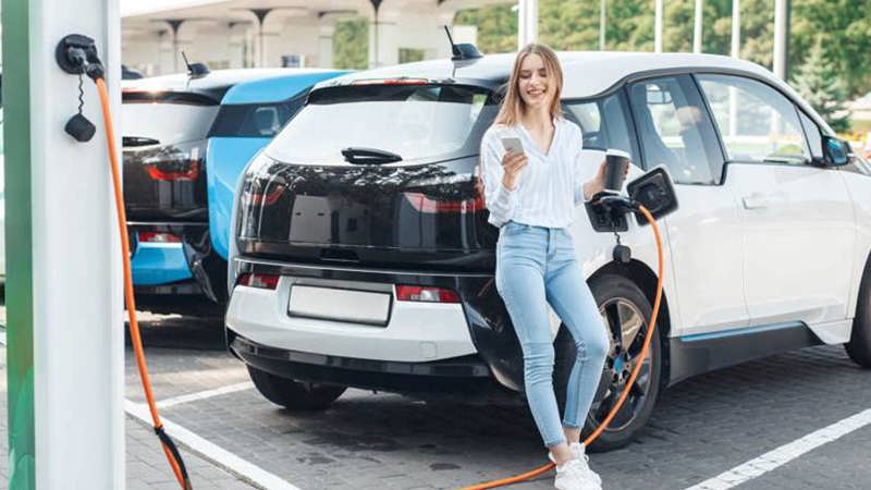 Woman using workplace EV charging